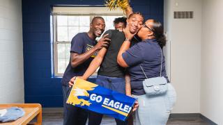 Mother kisses new Coppin student.